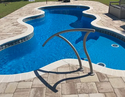 Able Pools and Spas transforms your backyard with the sleek Cyberlane w/ Spa San Juan pool, offering a modern design.